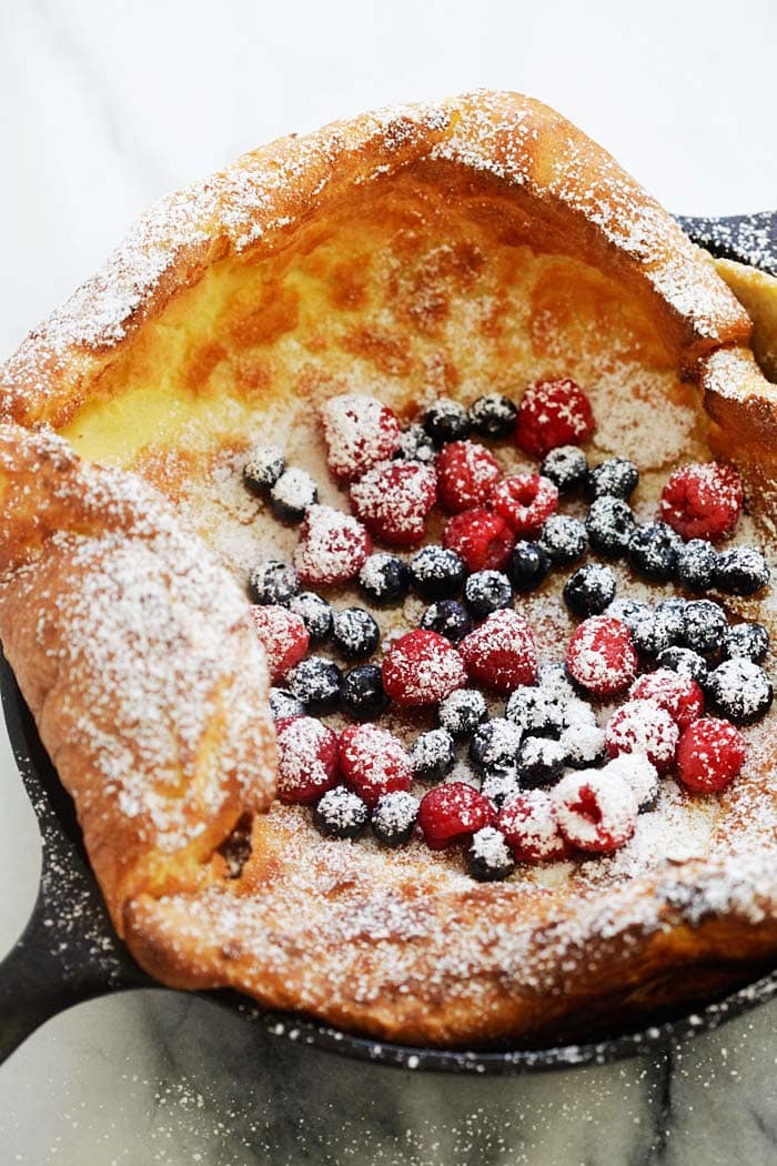 Dutch baby pancake with fresh berries and powdered sugar.