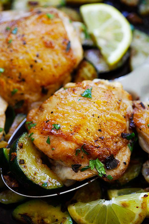 Close up Garlic Herb Chicken and Zucchini scooped on a large spoon.