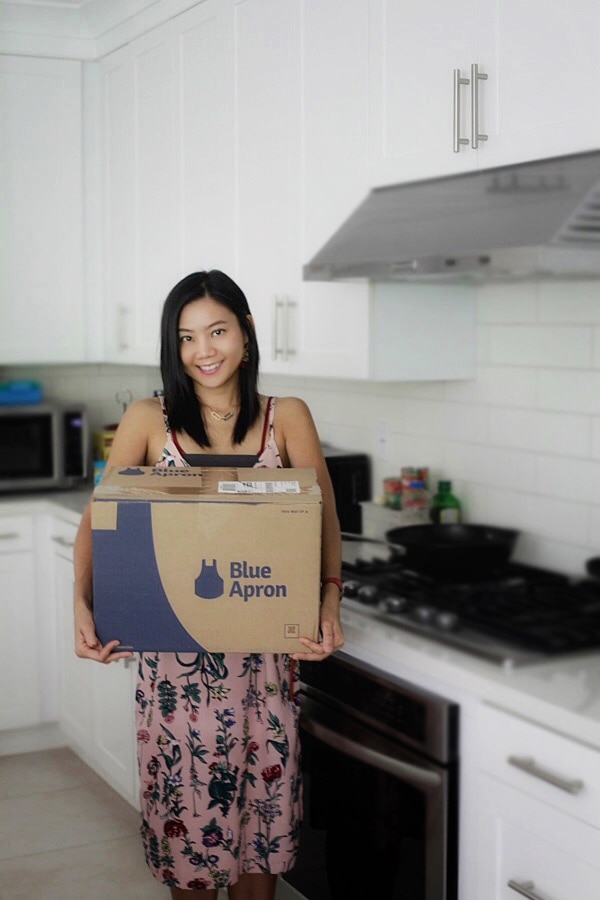 Bee holding a Blue Apron box.