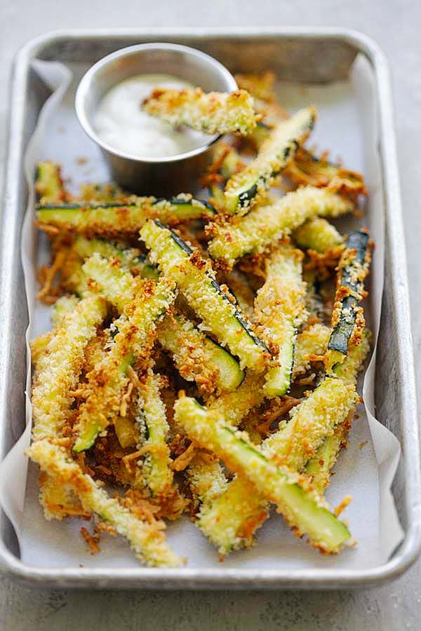 Zucchini fries baked in the oven with Japanese panko bread crumbs and Parmesan cheese.