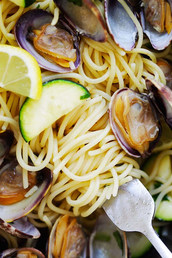 Al dente spaghetti in a fork with clams.