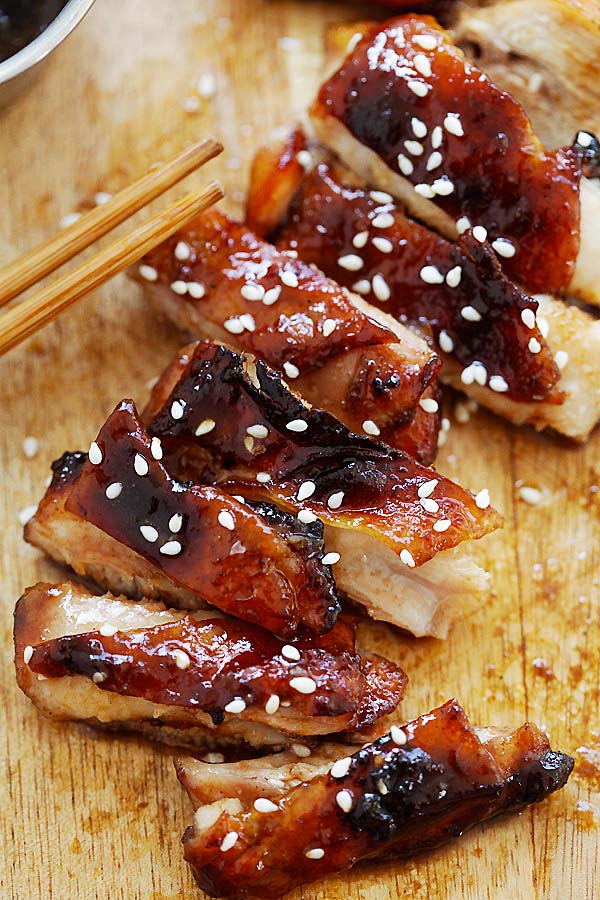 Oven-roasted Char Siu chicken with sweet, sticky and savory Chinese Char Siu marinade on a wooden chopping board.