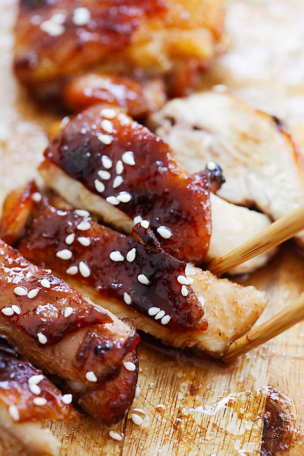 Char siu chicken with a pair of chopsticks.