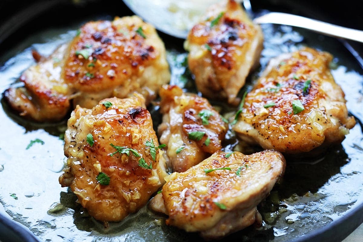 Dijon chicken cooked in a cast-iron skillet.