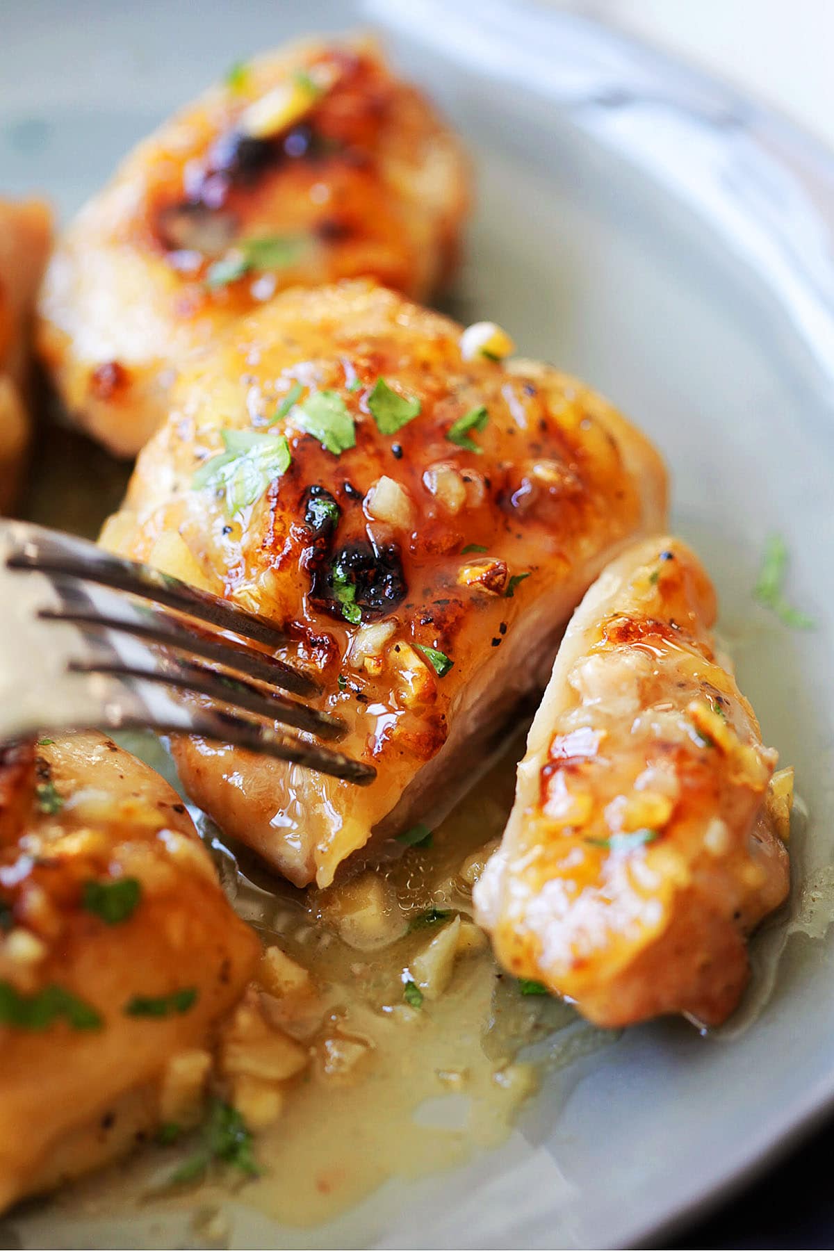 Juicy chicken dijon served on a plate with a fork. 