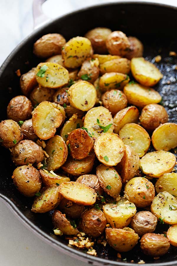 Easy and delicious Crispy Roasted Potatoes with herb infused oil ready to serve.
