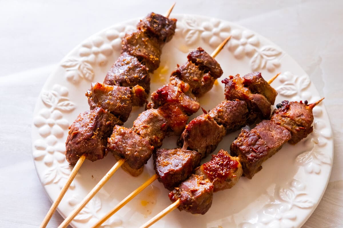 Grilled lamb skewers on a plate. 