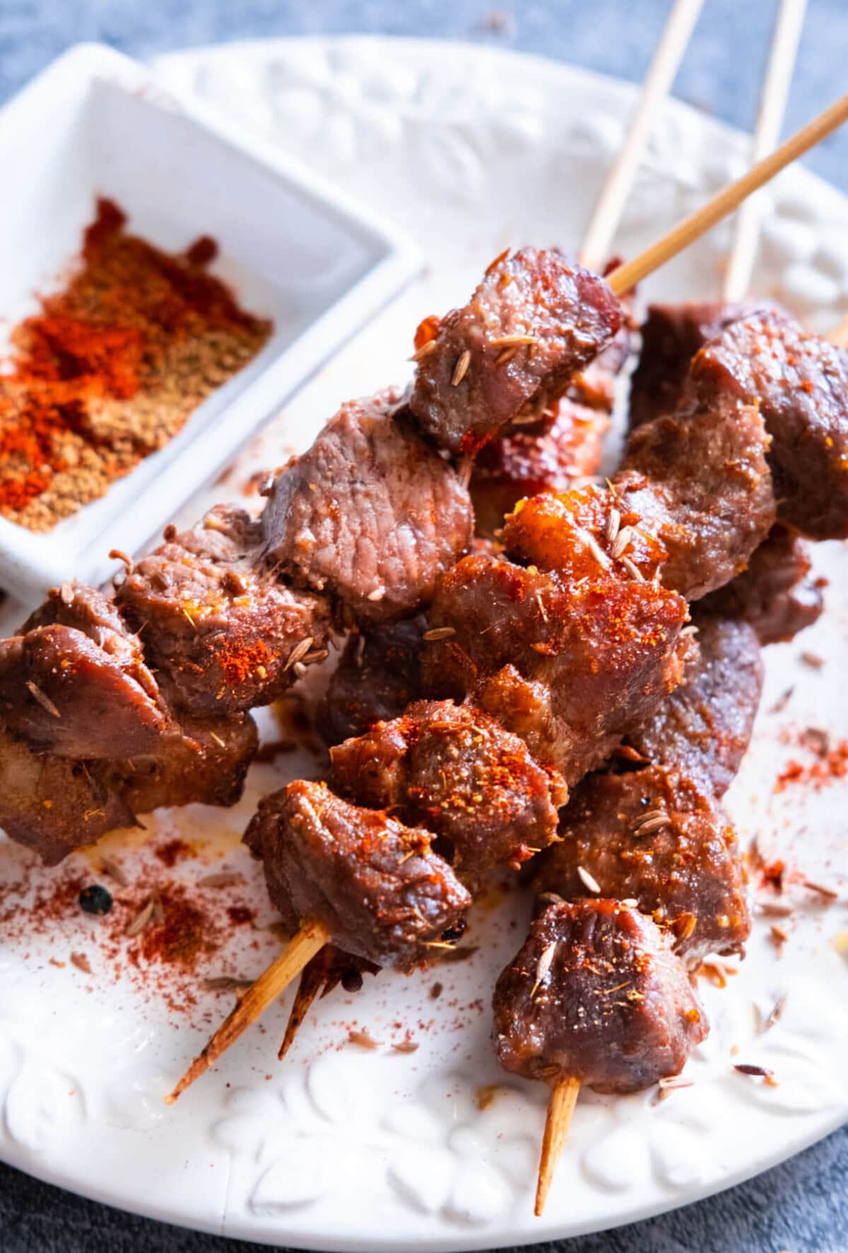 Cumin lamb skewers with chili powder and ground cumin sprinkled on top. 