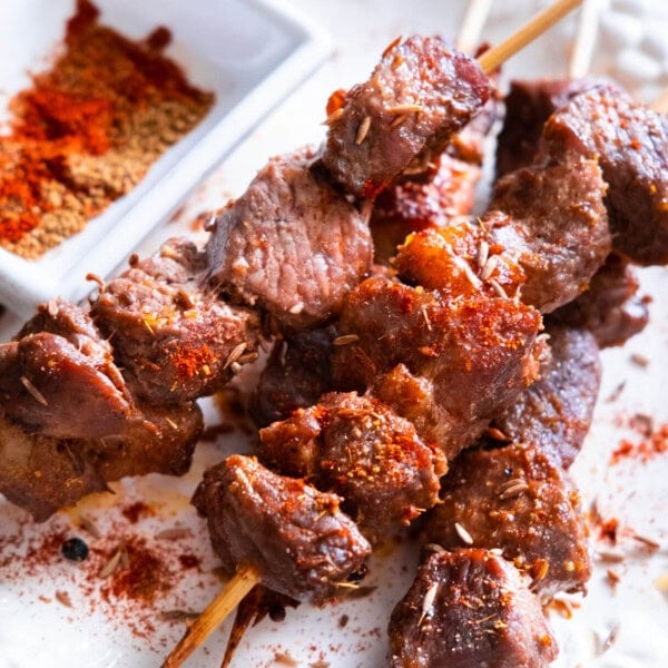 BBQ Cumin lamb skewers recipes with chili powder and ground cumin sprinkled on top.