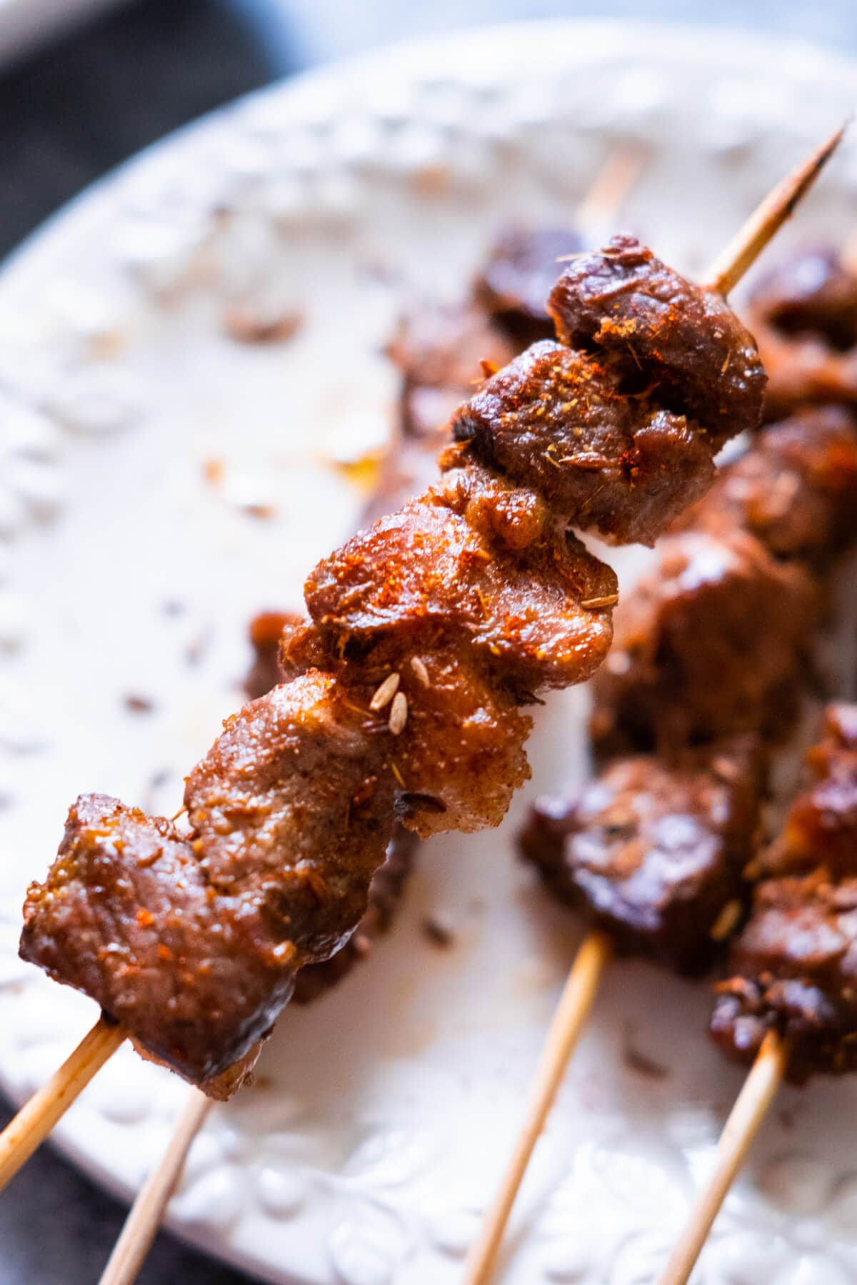 Close shot of a cumin lamb skewer. 