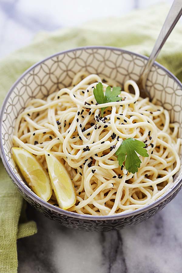Sesame noodles with a rich and creamy sesame sauce in a bowl.
