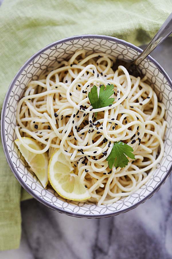 Top down view of sesame noodles in a bowl.