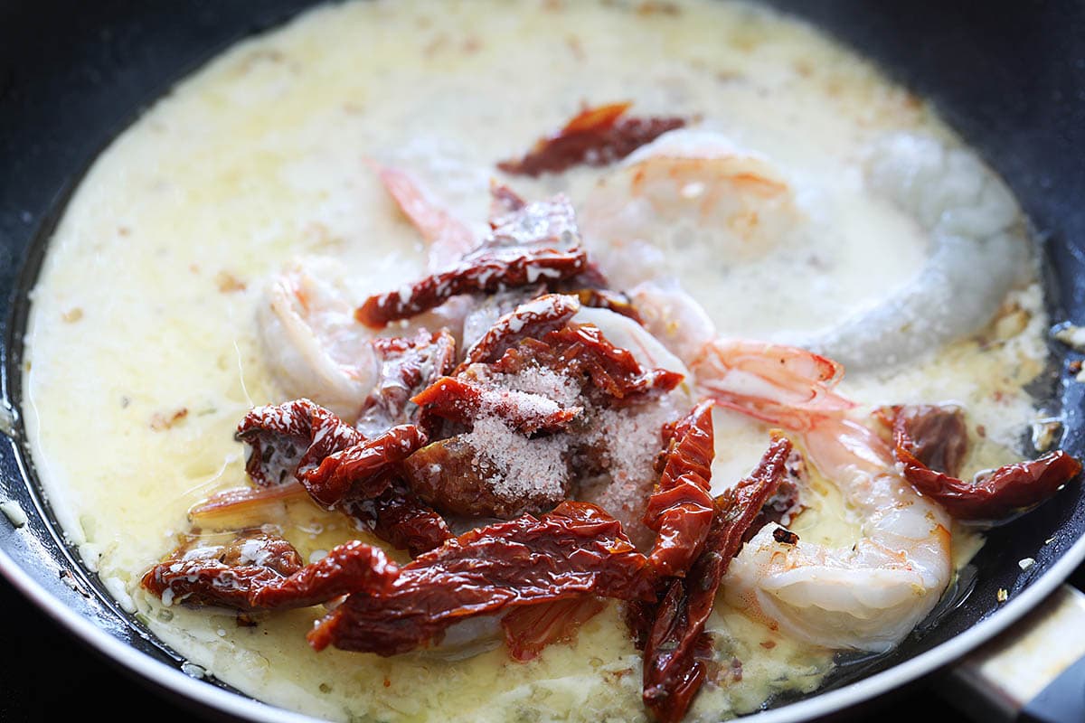 Creamy garlic sauce and shrimp in a skillet. 