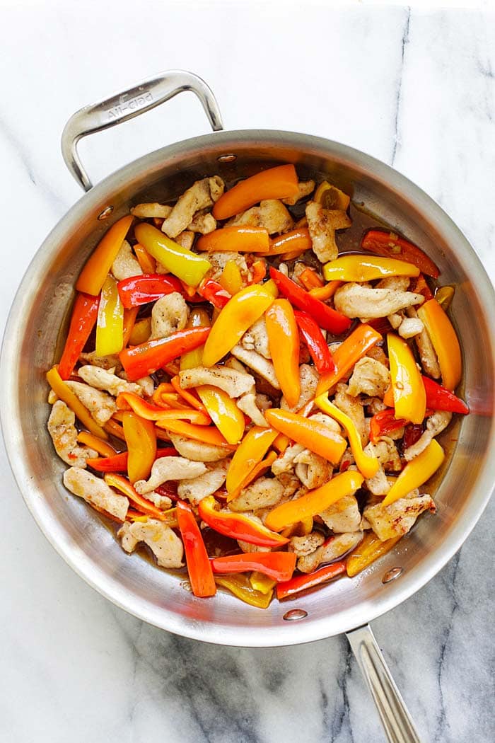 Quick and easy chicken stir-fry with mini sweet peppers, in a savory and sweet sauce made with Thai sweet chili sauce and oyster sauce in a skillet.