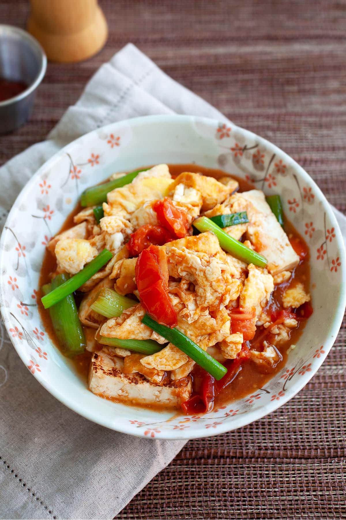 Tomato egg dish with tofu with sauce. 