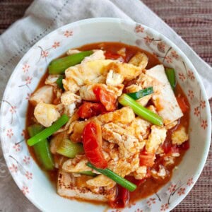 Tomato egg and tofu served on a plate.