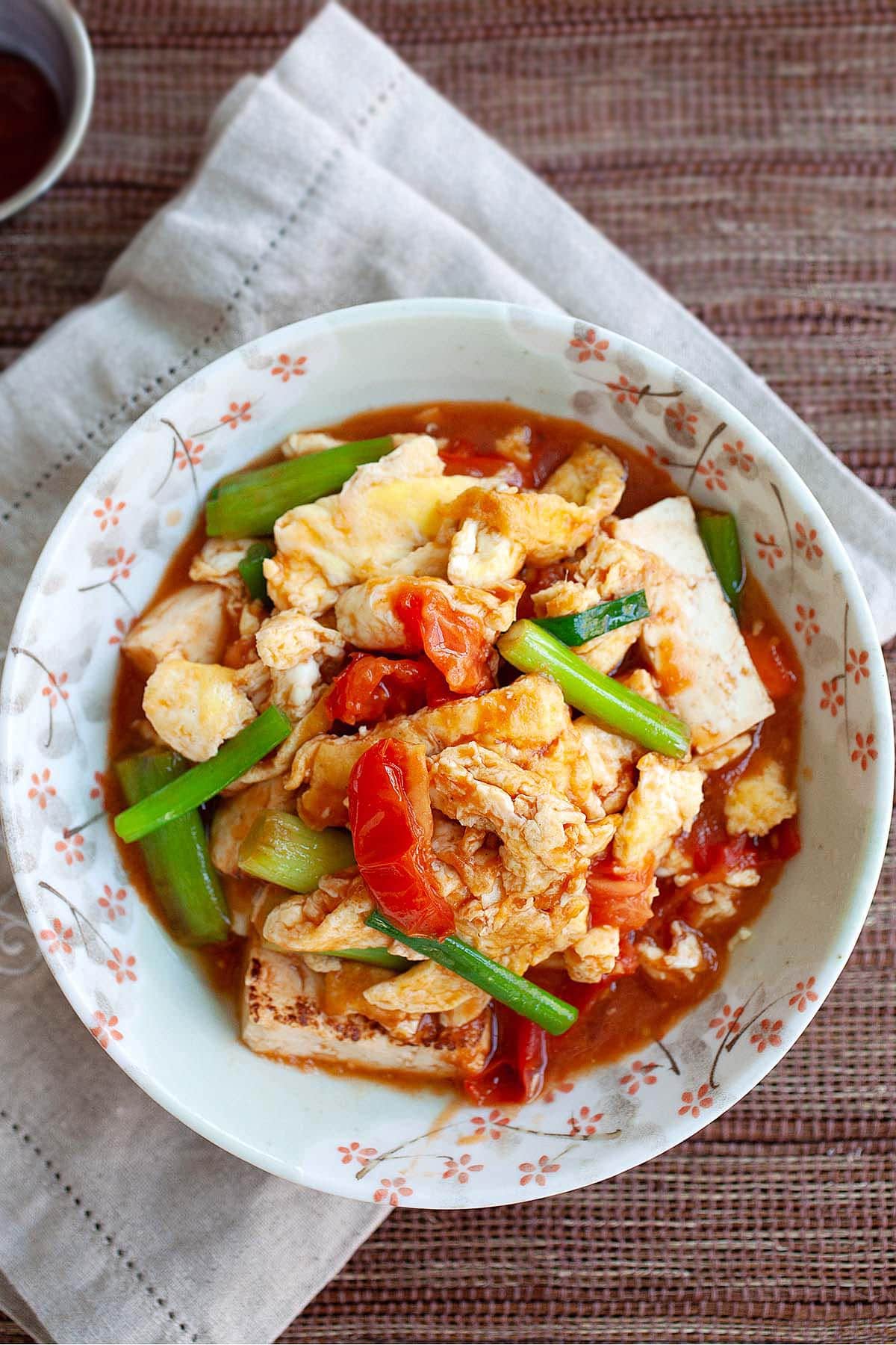 Tomato egg and tofu served on a plate. 