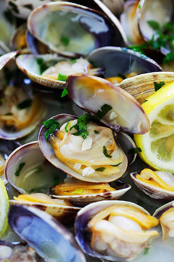 Close up of simple steamed clams in a beer broth.