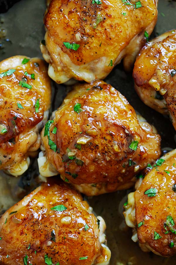 Close up of perfectly cooked Golden Sweet Garlic Chicken, topped with parsley.