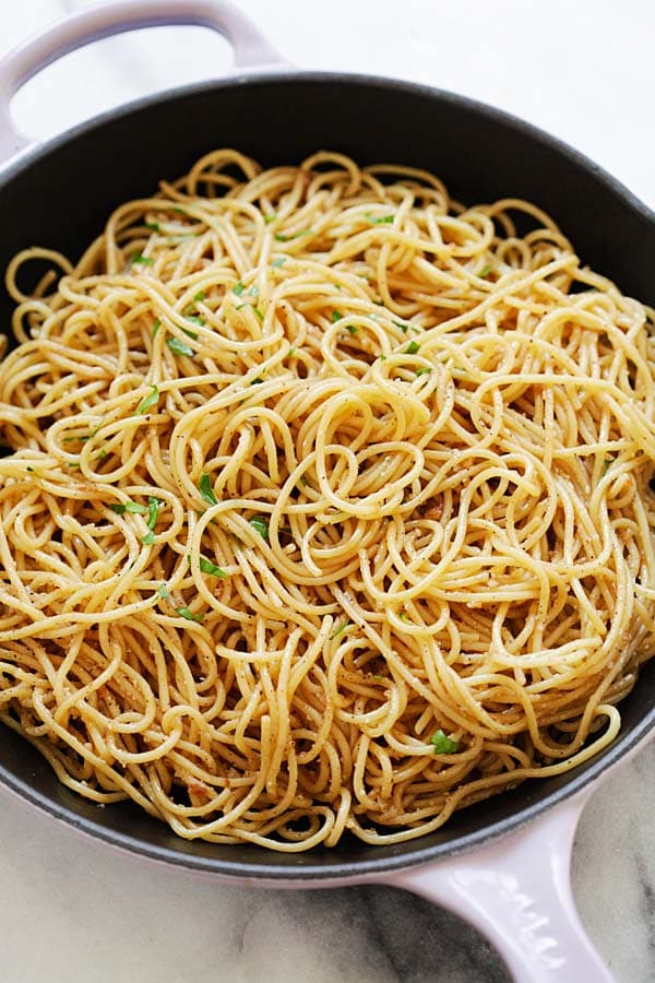 Brown butter garlic noodles made with garlic, brown butter, Parmesan cheese and oyster sauce in a skillet.