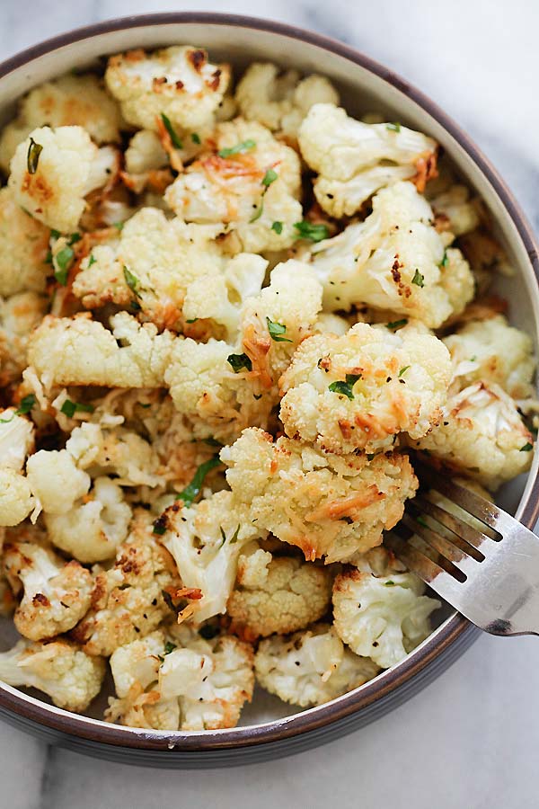 Delicious and easy garlic Parmesan roasted cauliflower garnished with chopped parsley.
