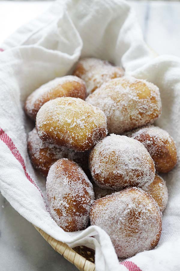 homemade easy sweet, light and fluffy Portuguese donuts dessert in a basket.
