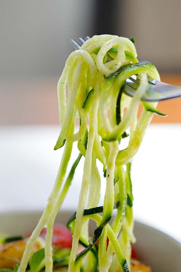 zucchini noodle salad picked by a fork.