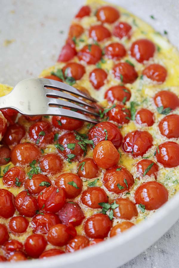 Homemade healthy Italian fritata with cherry tomatoes at the top.