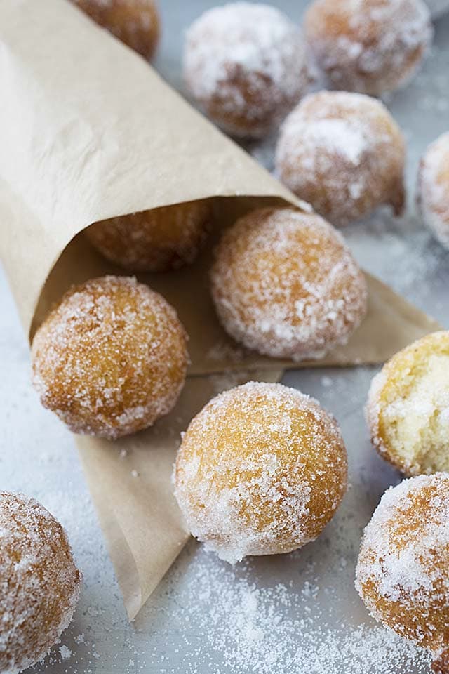 Top down picture of donut holes coated with fine sugar.