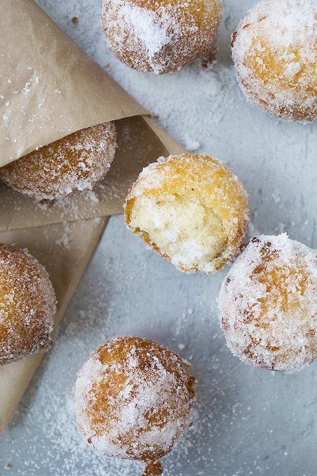 Golden brown donut holes coating in sugar. 