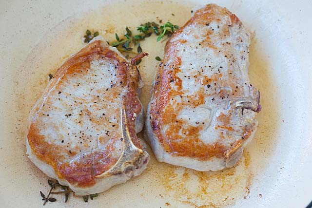 Pork chop recipes in a skillet.