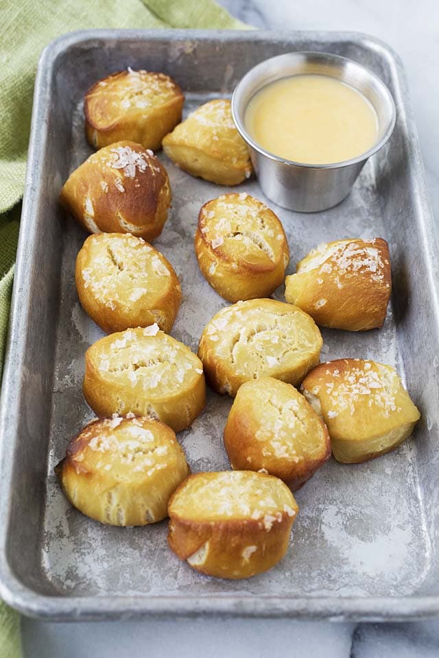 Close up shot of pretzel bites with cheese sauce dipping sauce.