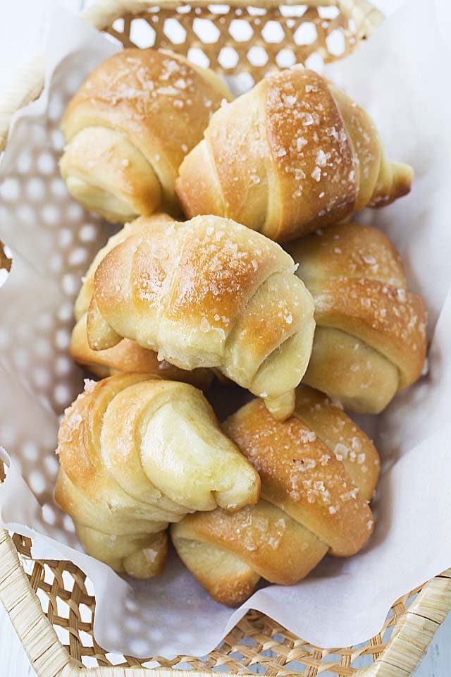 Easy and quick homemade baked sea salt butter rolls, served in a basket.