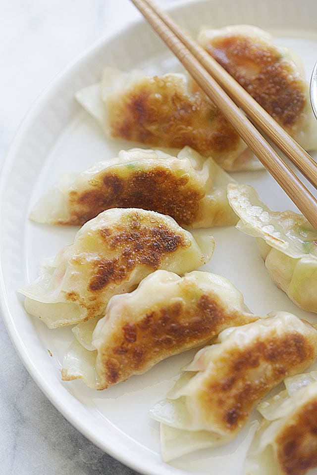 Easy Chinese Potstickers on a serving platter with dipping sauce.