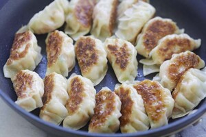 Pan-frying potstickers on a non-stick pan.