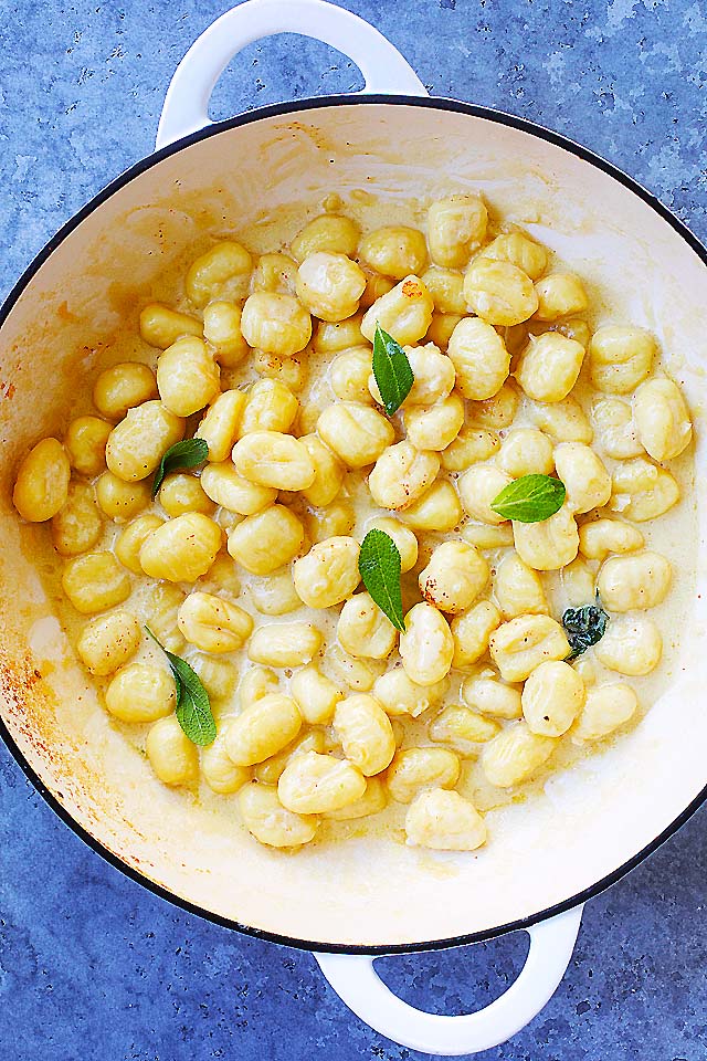 Perfectly cooked gnocchi in creamy garlic Parmesan sauce, in a skillet.