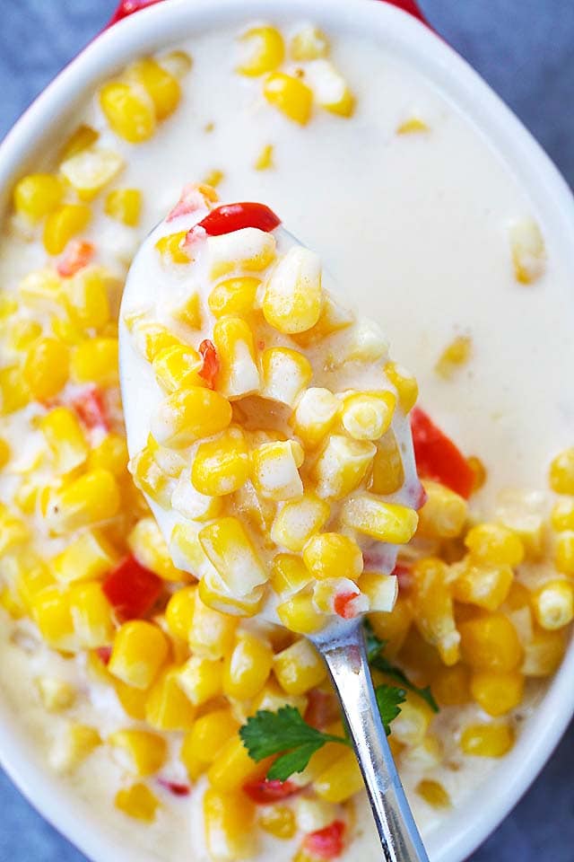 A spoonful of creamy cream corn, ready to be eaten.