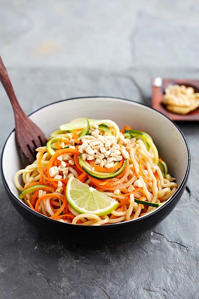 Healthy homemade zucchini noodles with Thai peanut sauce served in a bowl, ready to be eaten.