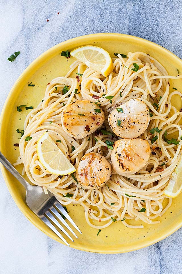 Creamy sea scallop pasta on a plate, ready to be served.