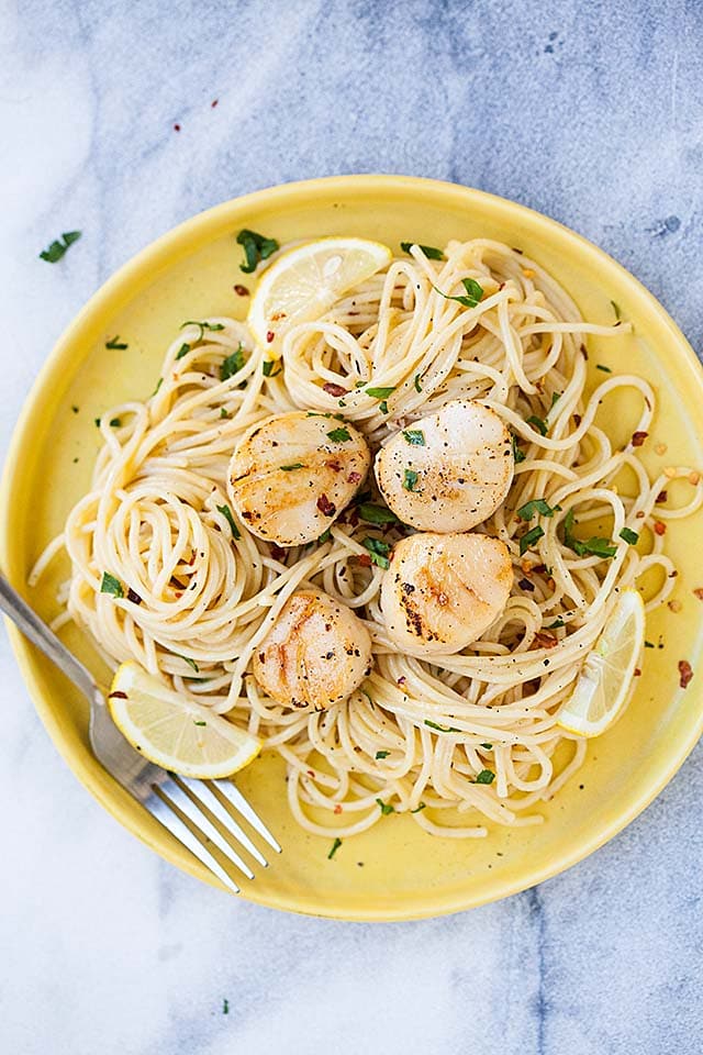 Easy creamy white wine scallop spaghetti recipe garnished with parsley. 