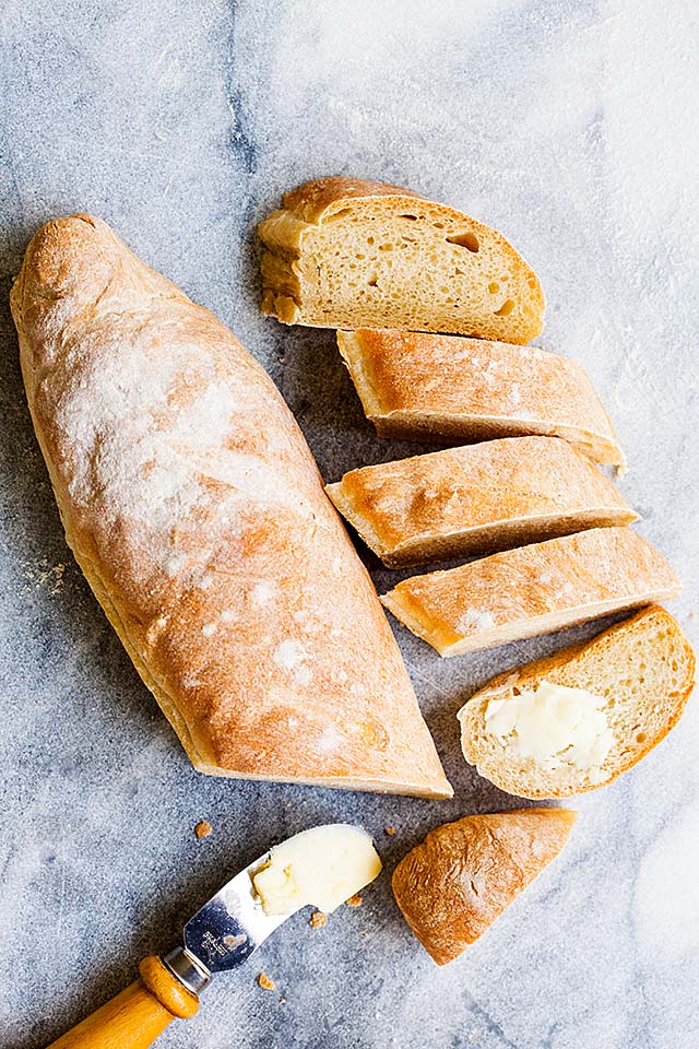 French baguette sliced into pieces and served with butter.