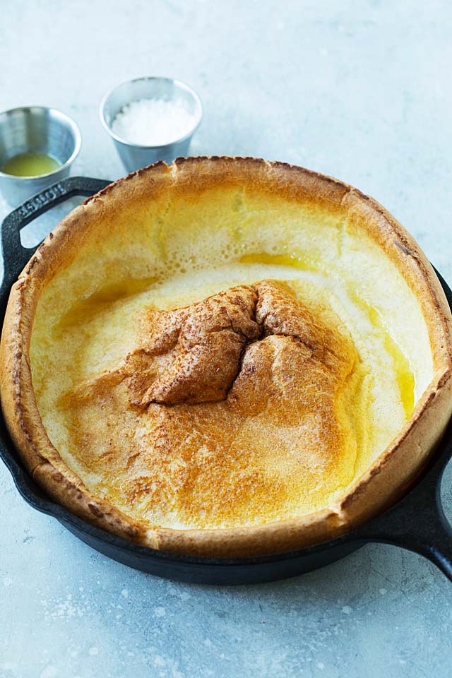 Hot oven-baked German pancake in a cast-iron skillet.