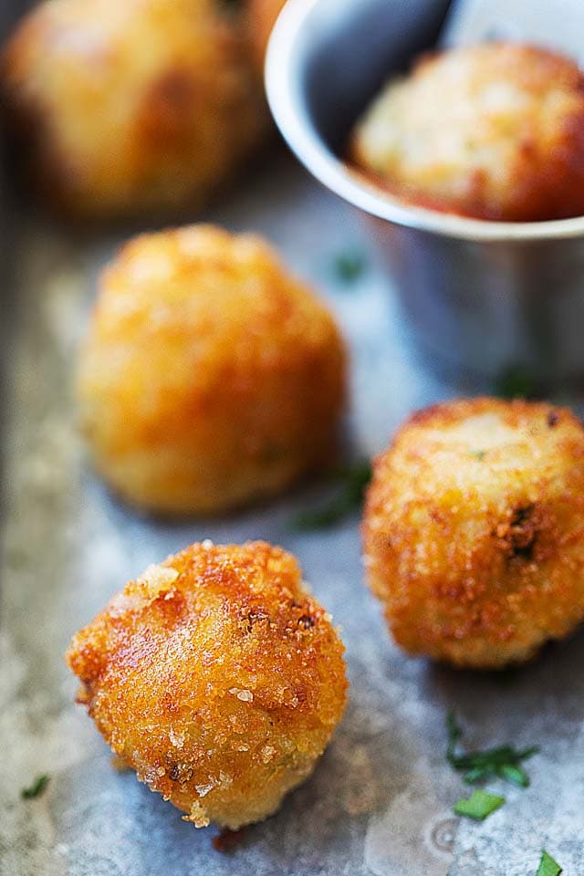 Close up of potato balls, deep-fried to golden brown.