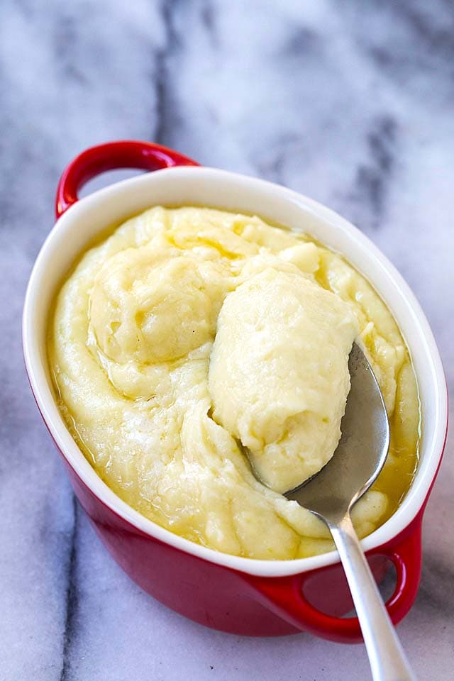 Creamy mashed potatoes ready to be served, with a spoon.