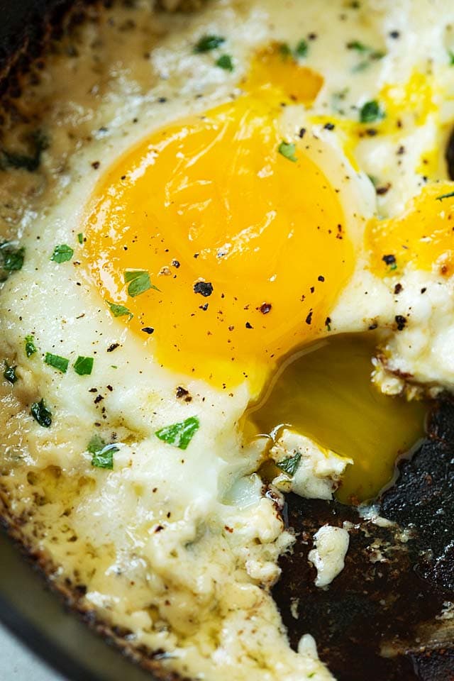 Close up of Parmesan eggs with runny egg yolks, ready to be served.