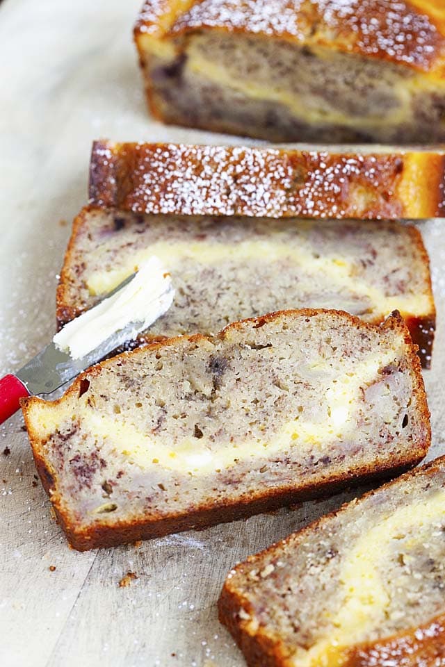 Cream cheese banana bread with a layer of cream cheese in the middle of the banana bread.
