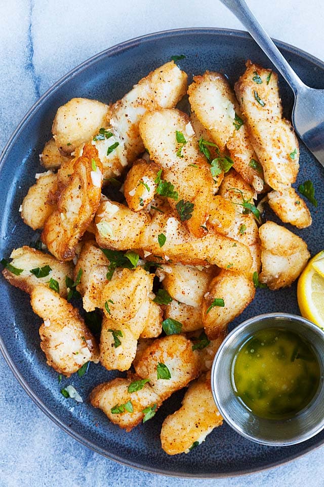 Garlic butter fish on a plate.