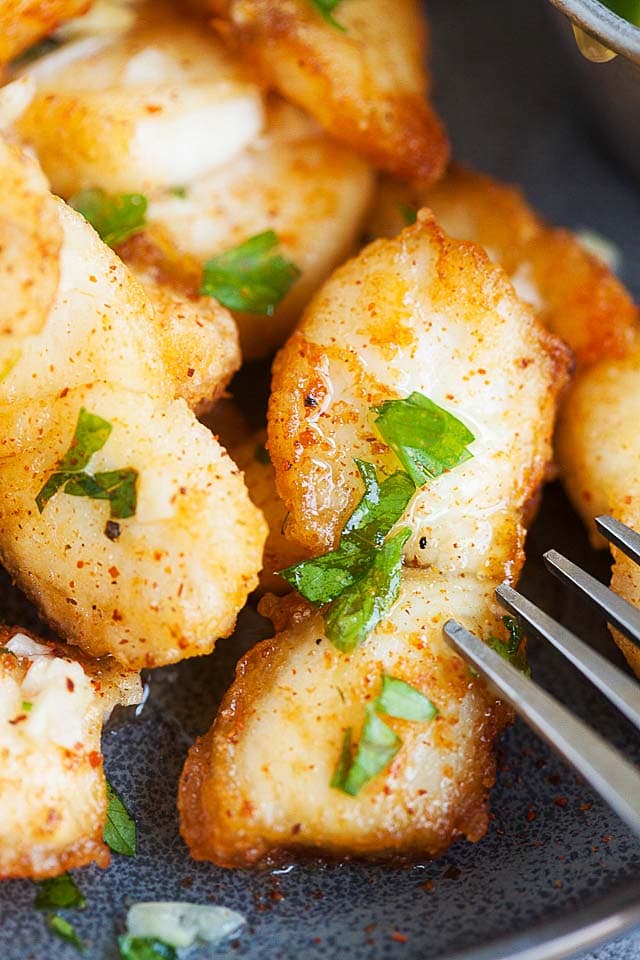 Garlic butter fish on a plate, ready to serve.