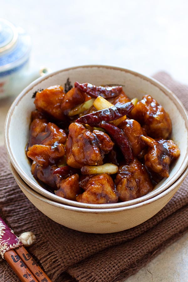 General Tso's Chicken in a Chinese bowl, with a pair of chopsticks.