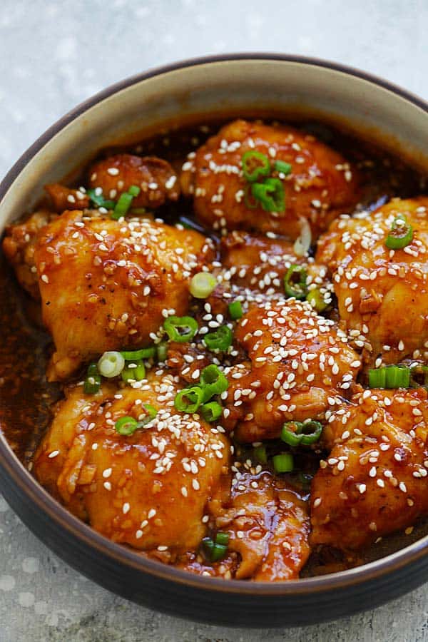 Honey Sesame Chicken thighs served in a white bowl.